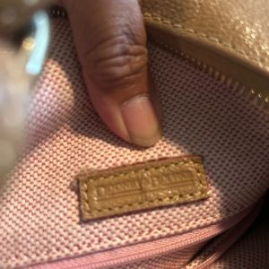 Dooney and Bourke shoulder bag , beige color. Still in good condition .